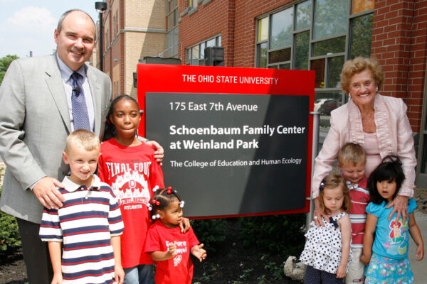 Betty Schoenbaum and children at sign