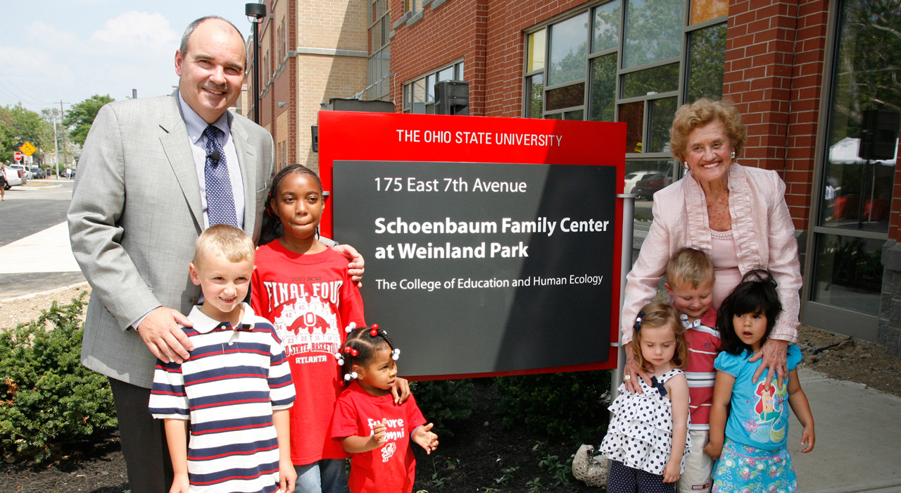 Betty Schoenbaum and children at sign