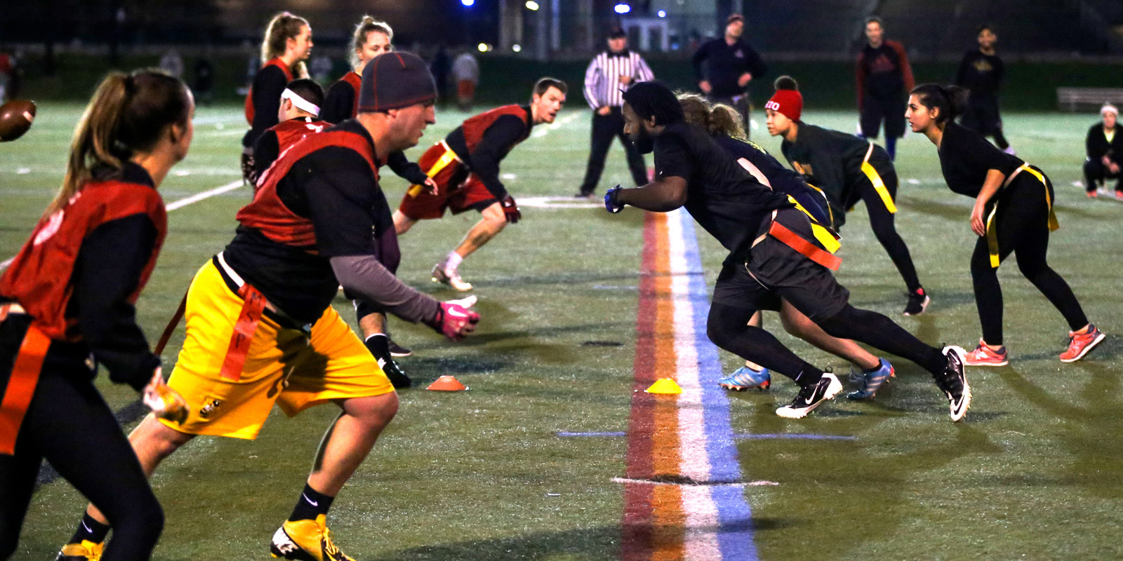 Ohio State students run a play during a coed recreation flag football game