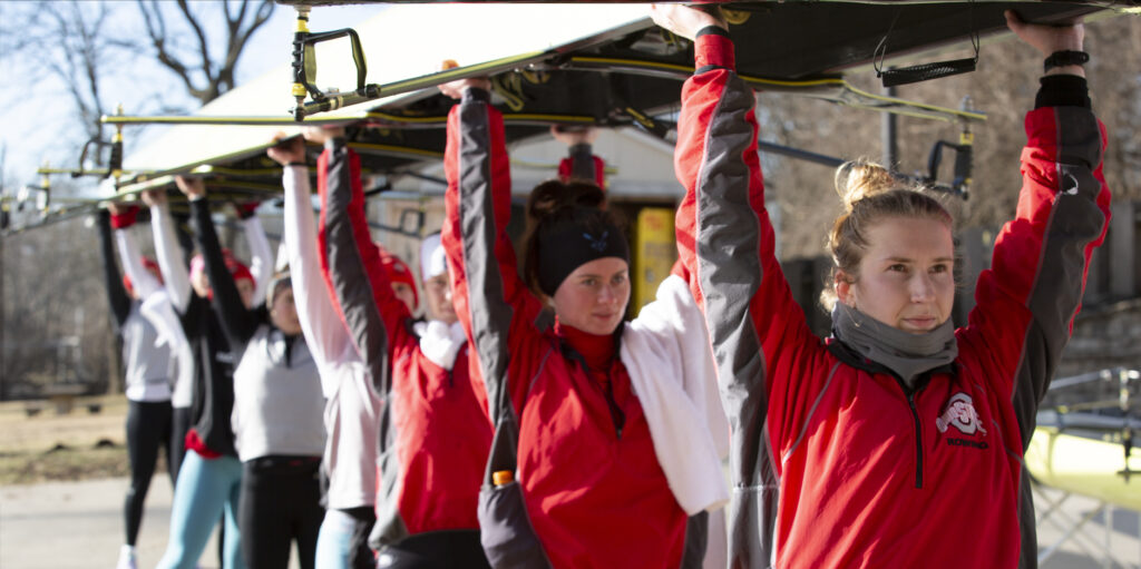 Ohio State womens rowing team carrying boat