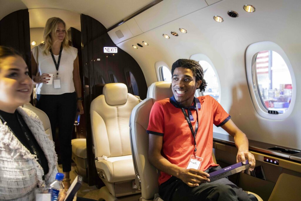 Ohio State student sitting in NetJets airplane during tour