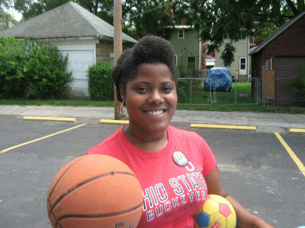 Ashley Hicks holding a basketball in an Ohio State shirt
