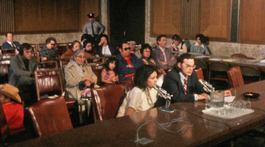 Court room in the 1980's with man and woman at the front table