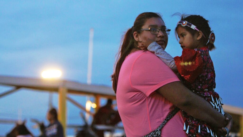 Native American woman holding her child