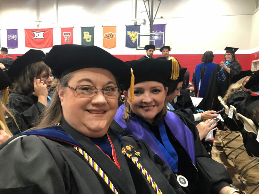 Women posing for selfie at graduation ceremony