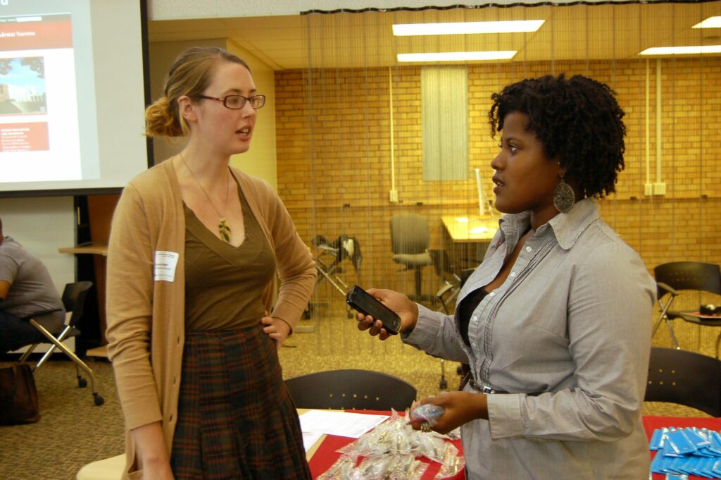 Ashley Hicks interviewing student at an event