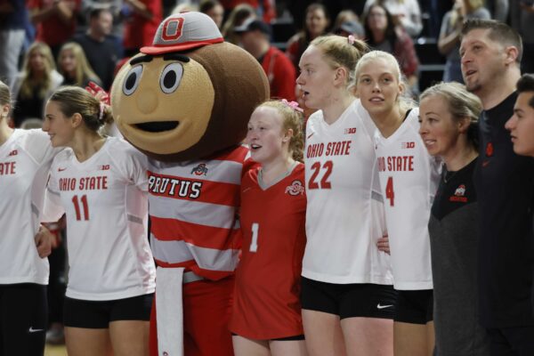 Sarah Morbitzer stands with Brutus the Buckeye and her Ohio State volleyball teammates