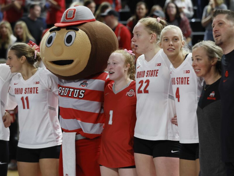 Sarah Morbitzer stands with Brutus the Buckeye and her Ohio State volleyball teammates