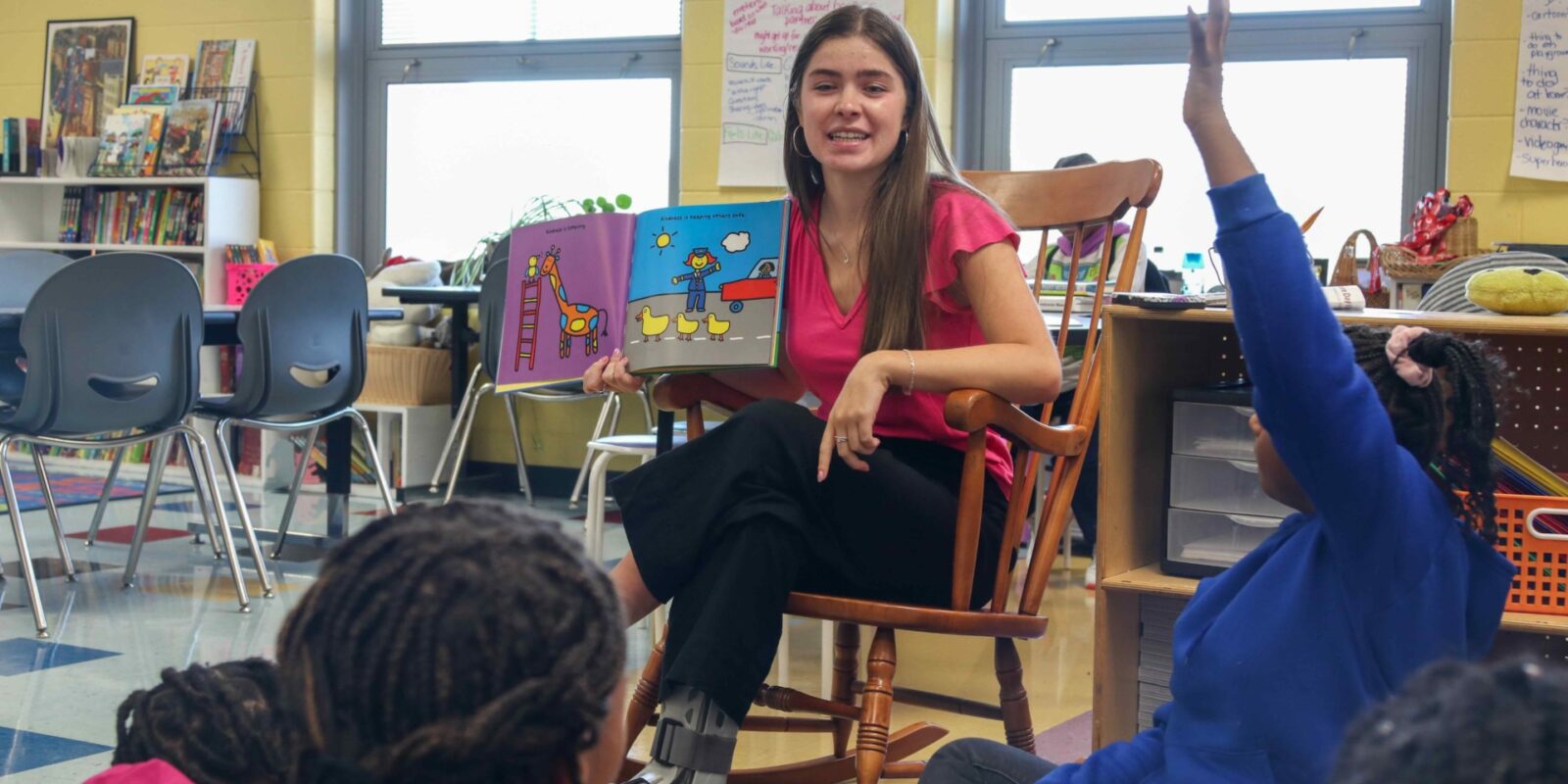 Teacher Zoe Lightcap reading to a group of young students