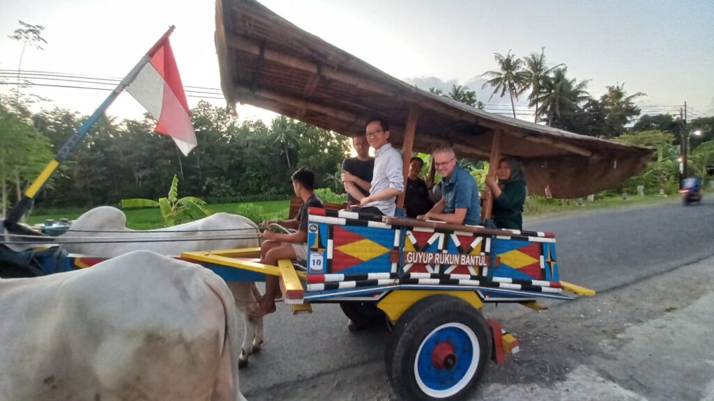 Ohio State team traveling on a wagon pulled by oxen