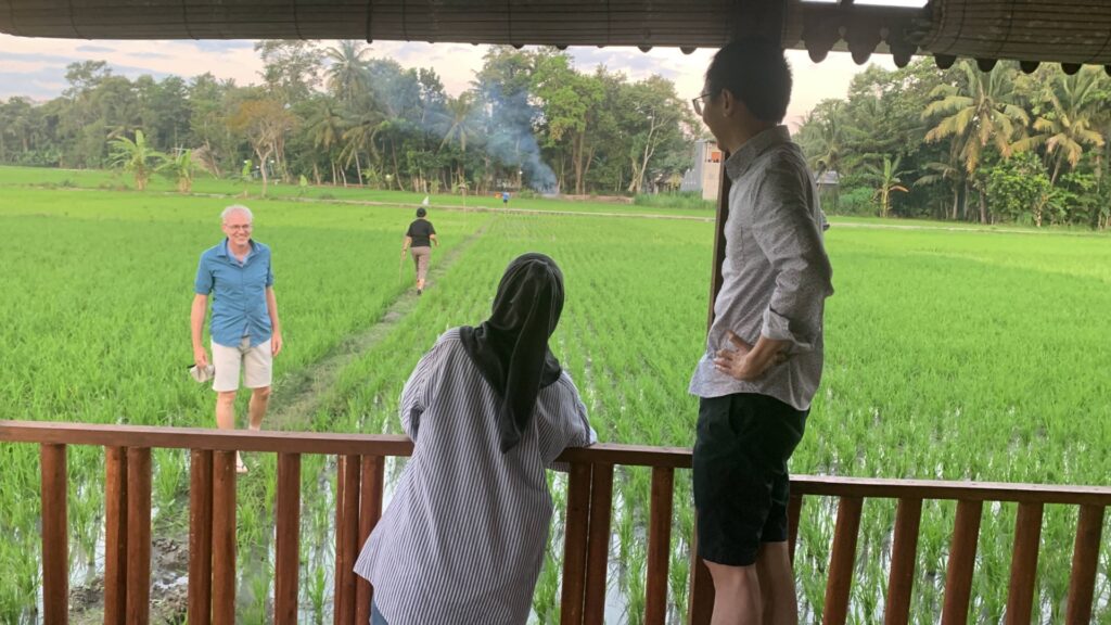 Ivan Stefano and other Ohio State travel abroad participants overlooking a field during their trip to Indonesia