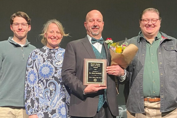 Steve Kucinski receiving an award with his family on stage