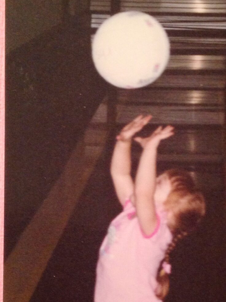 Sarah Morbitzer at a young age playing with a volleyball