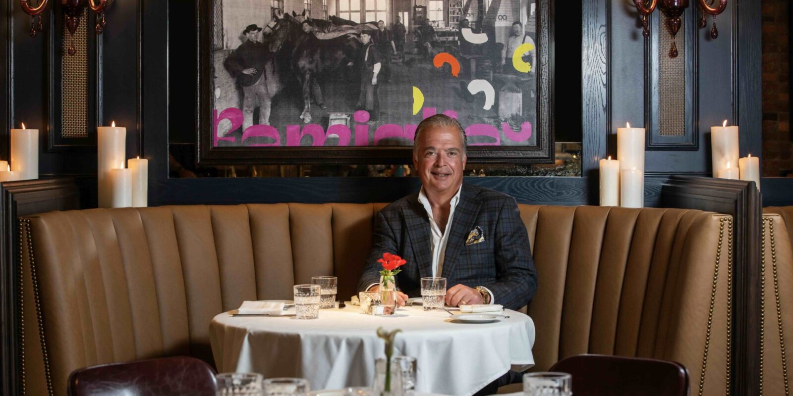 Cameron Mitchell sitting at a table in one of his Columbus restaurants