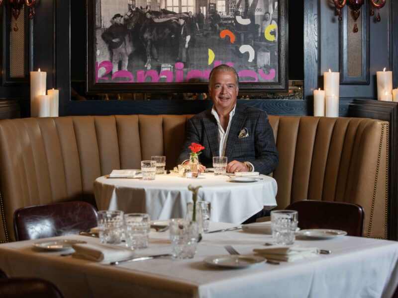 Cameron Mitchell sitting at a table in one of his Columbus restaurants